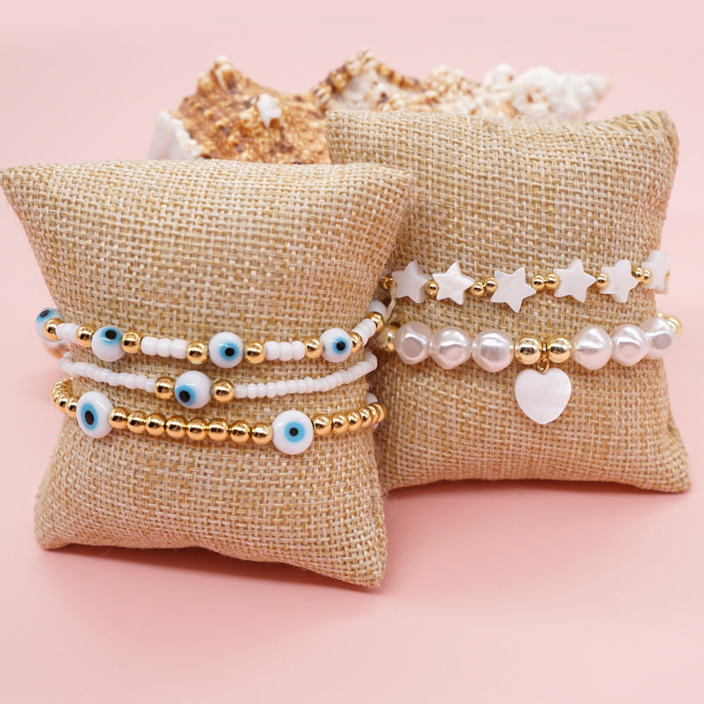 Ojos navideños al por mayor flor anillo de oro sonriente hebilla pulsera de vidrio elástico